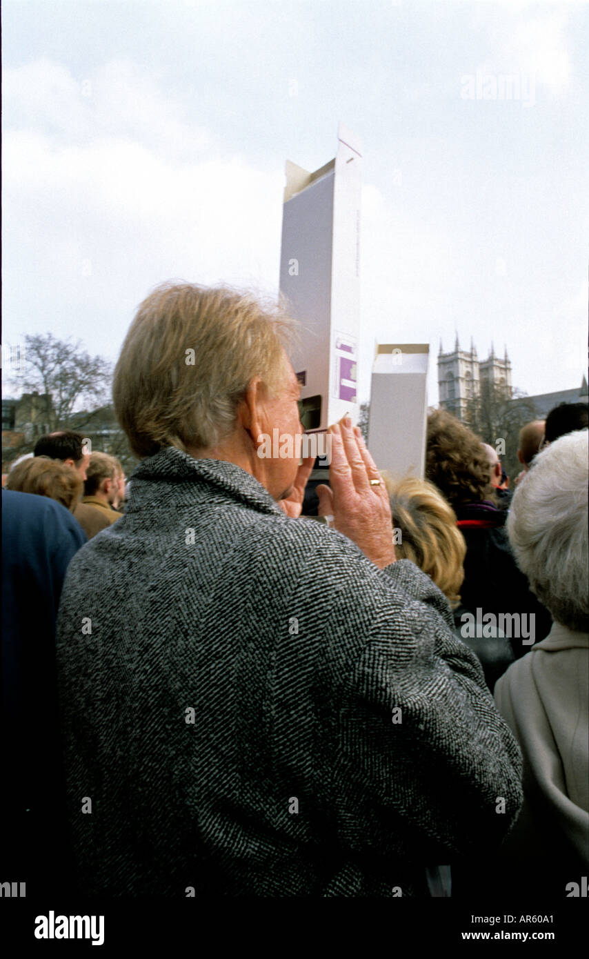 Man watching Queen Mother s funeral procession through periscope Stock Photo