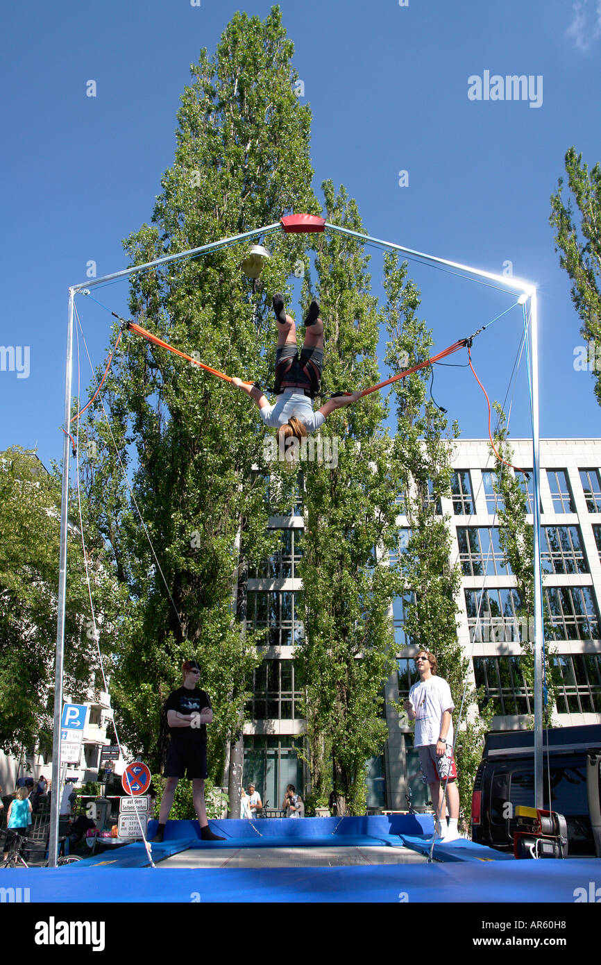 Girl bouncing on Trampolin with bungee jumping Stock Photo Alamy