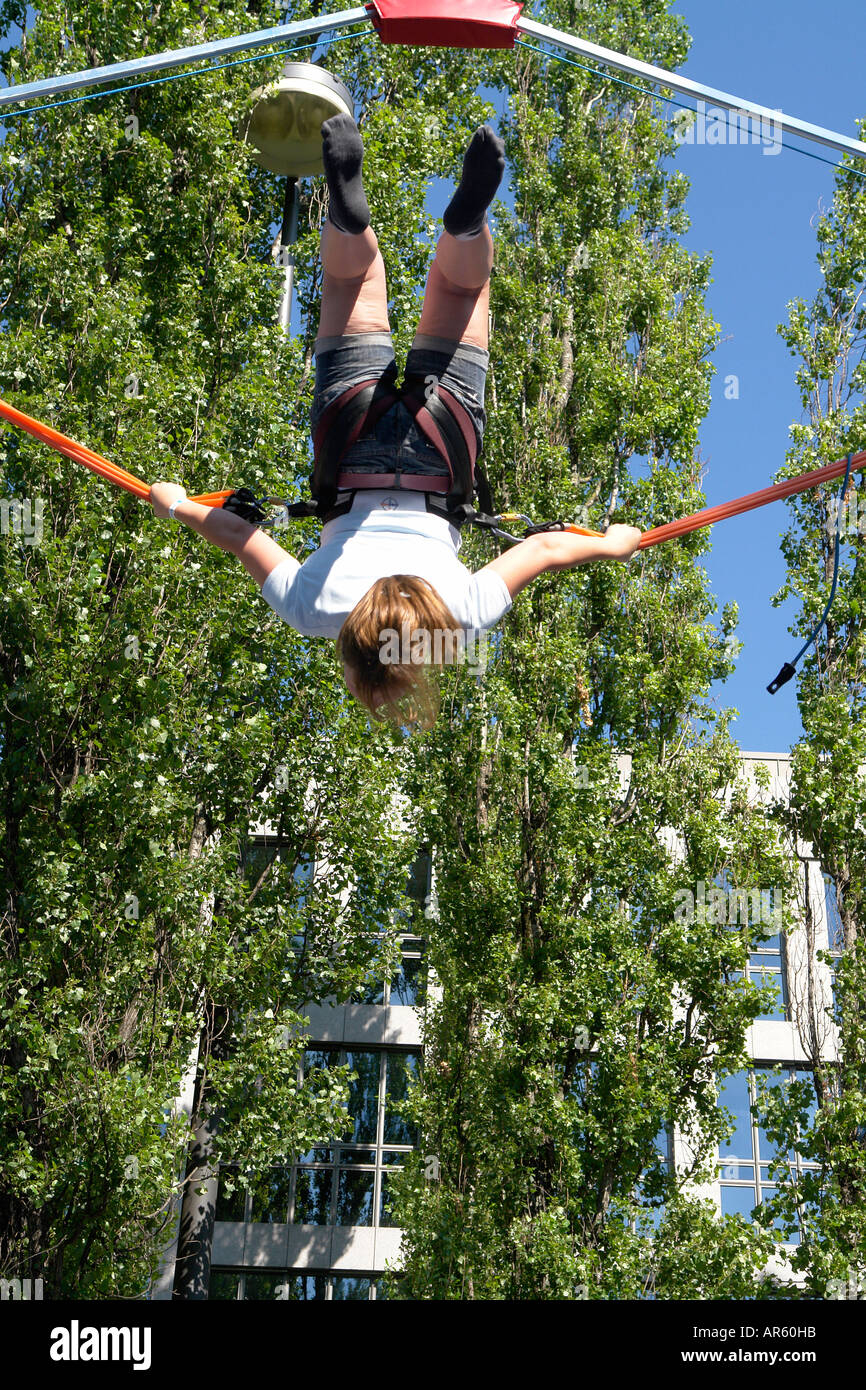 Girl bouncing on Trampolin with bungee jumping Stock Photo Alamy