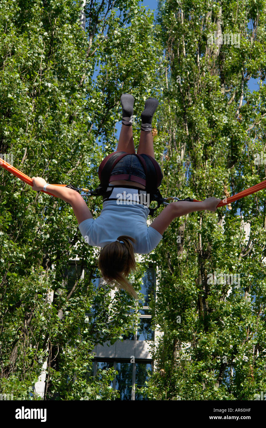 Girl bouncing on Trampoline with bungee jumping Stock Photo Alamy