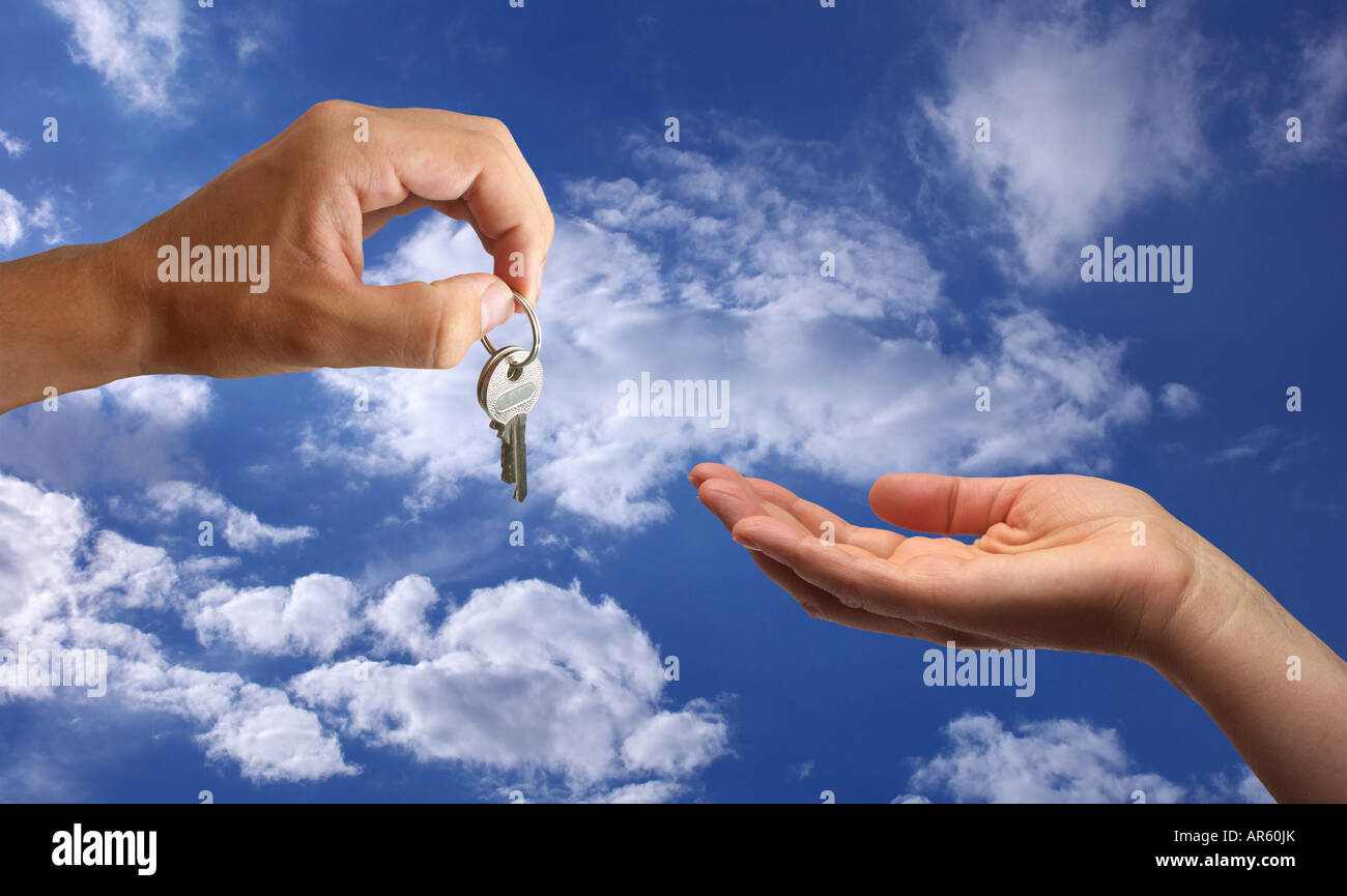 Key handover on front of blue sky background Stock Photo - Alamy