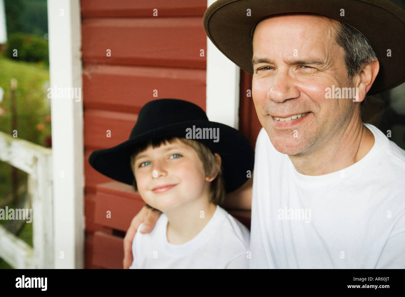 Father and son wearing cowboy hats Stock Photo