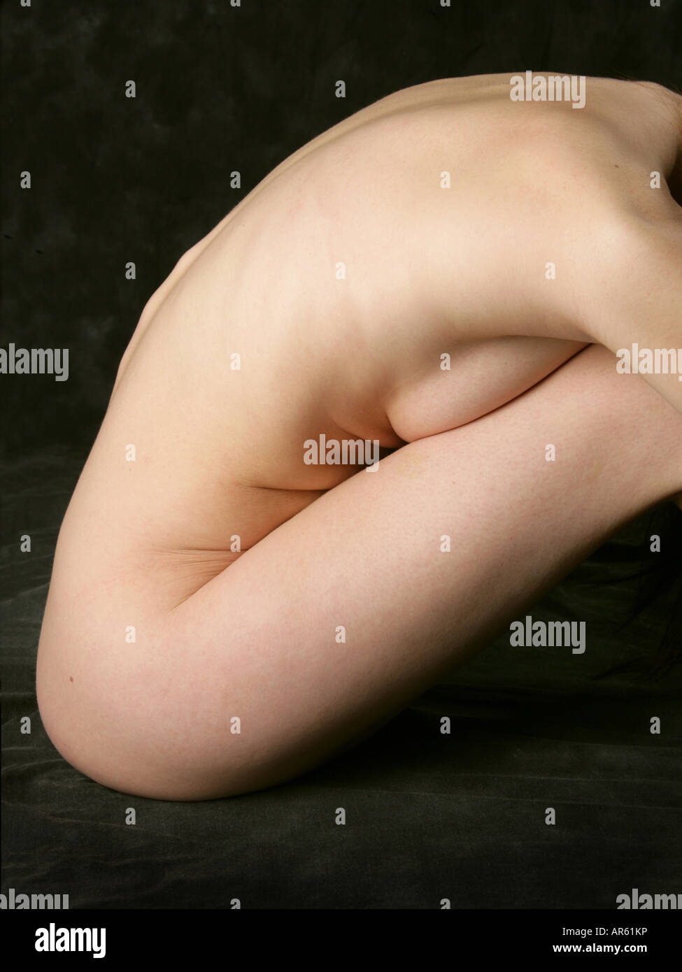 Side View of a Sitting Nude Woman Stock Photo