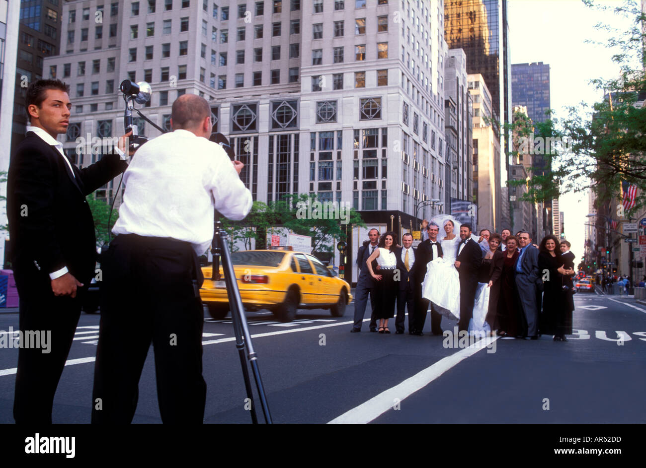 Family wedding group and photographer in photo group situation in 5th Avenue Manhattan New York City USA Stock Photo