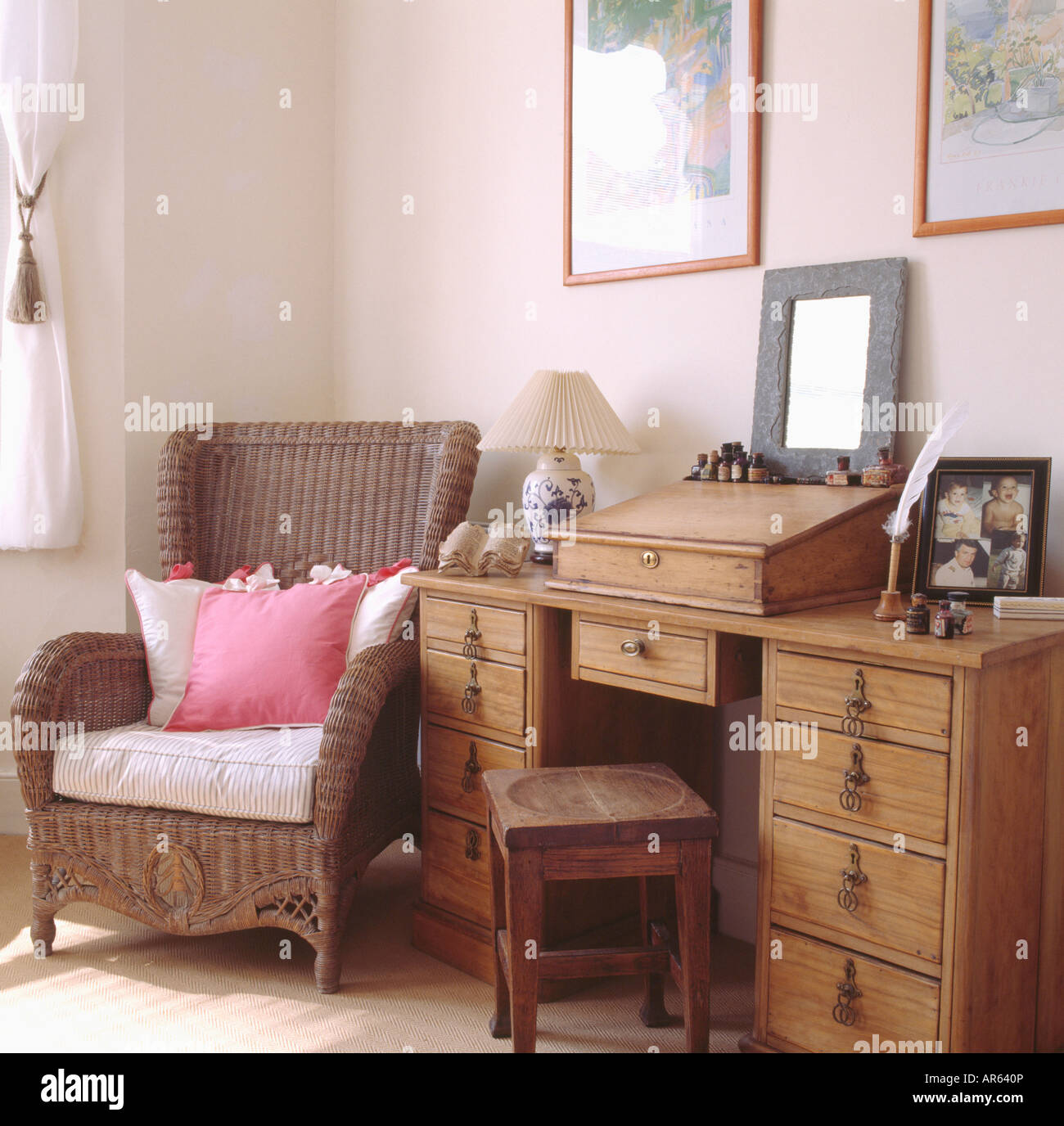 Pink White Cushions On Wicker Armchair Beside Old Pine Desk And