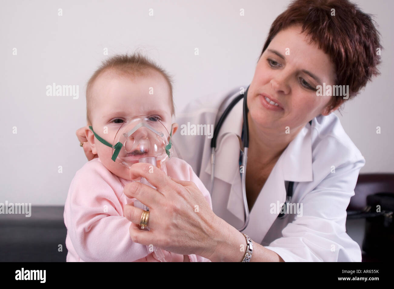 Seven month old baby with a nebulizer mask Stock Photo