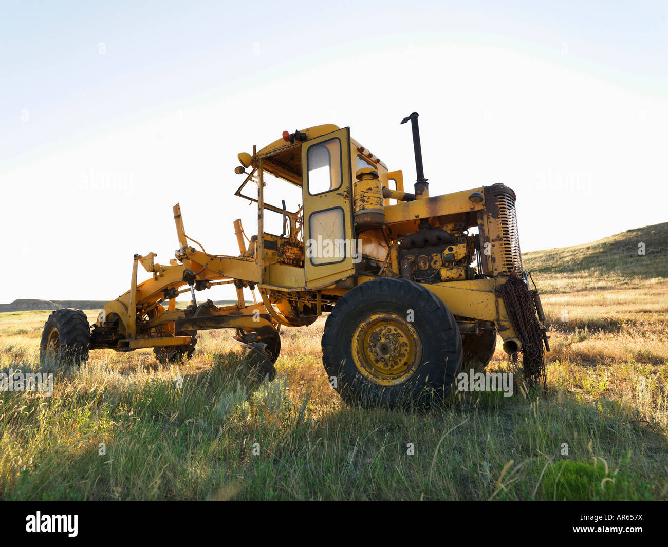 Yellow tractor in field Stock Photo