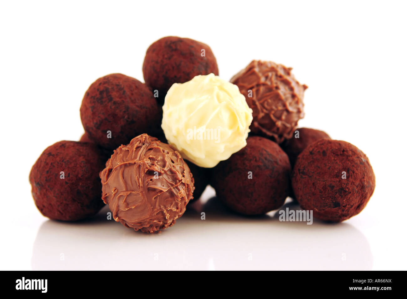 Pile of assorted chocolate truffles isolated on white background Stock Photo