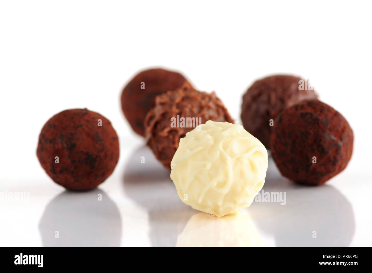 Several assorted chocolate truffles isolated on white background Stock Photo