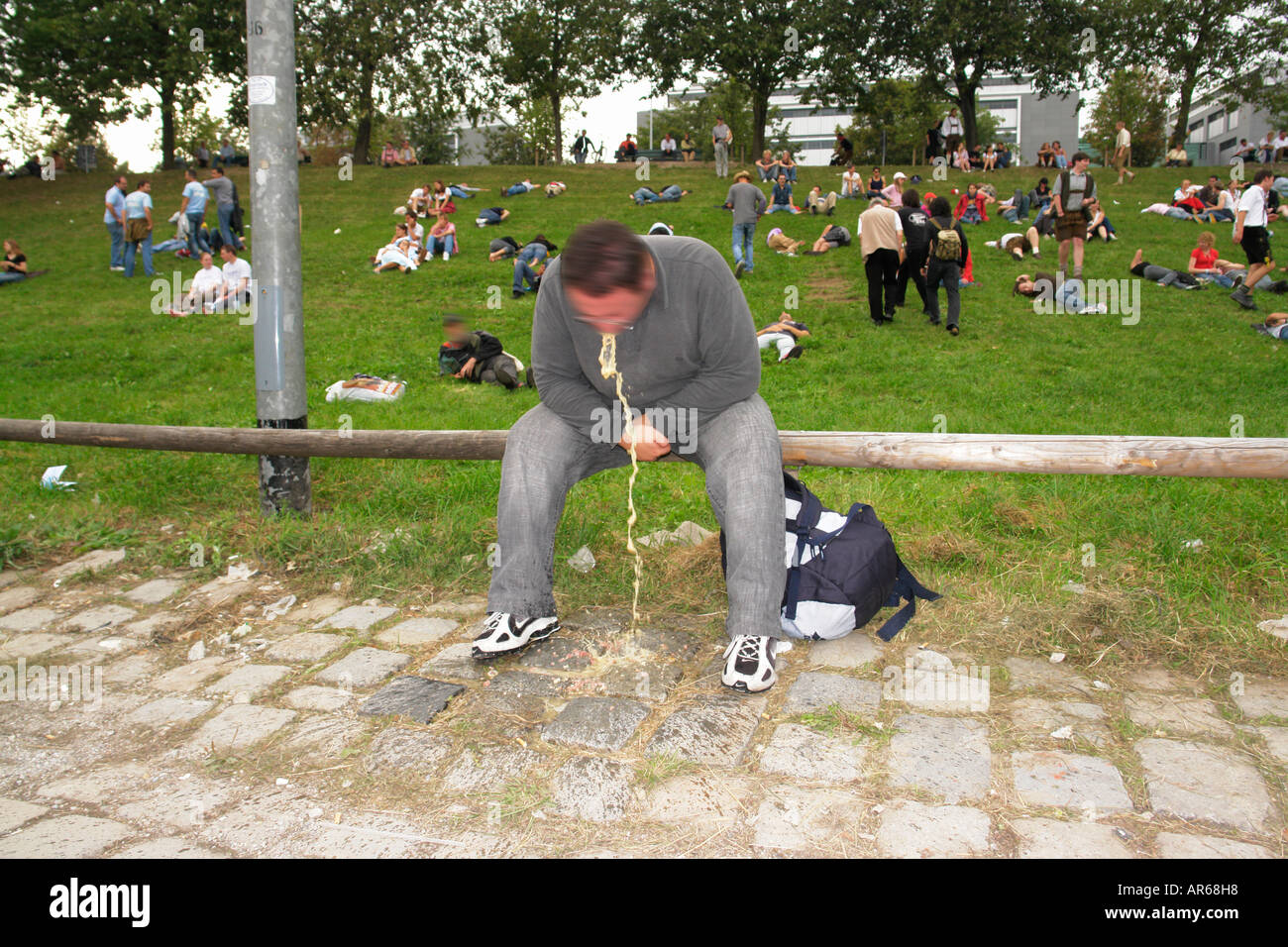 Drunken man vomiting on the way back home Oktoberfest in Theresienwiese Munich Bavaria Germany Stock Photo