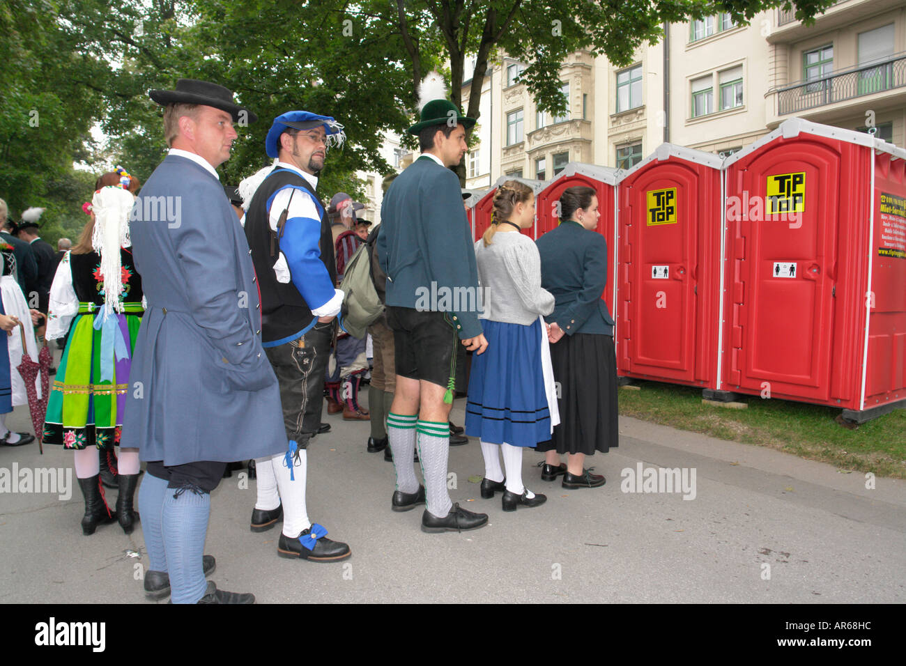 People lineup for mobile toilet Oktoberfest in Munich Bavaria Germany Stock Photo