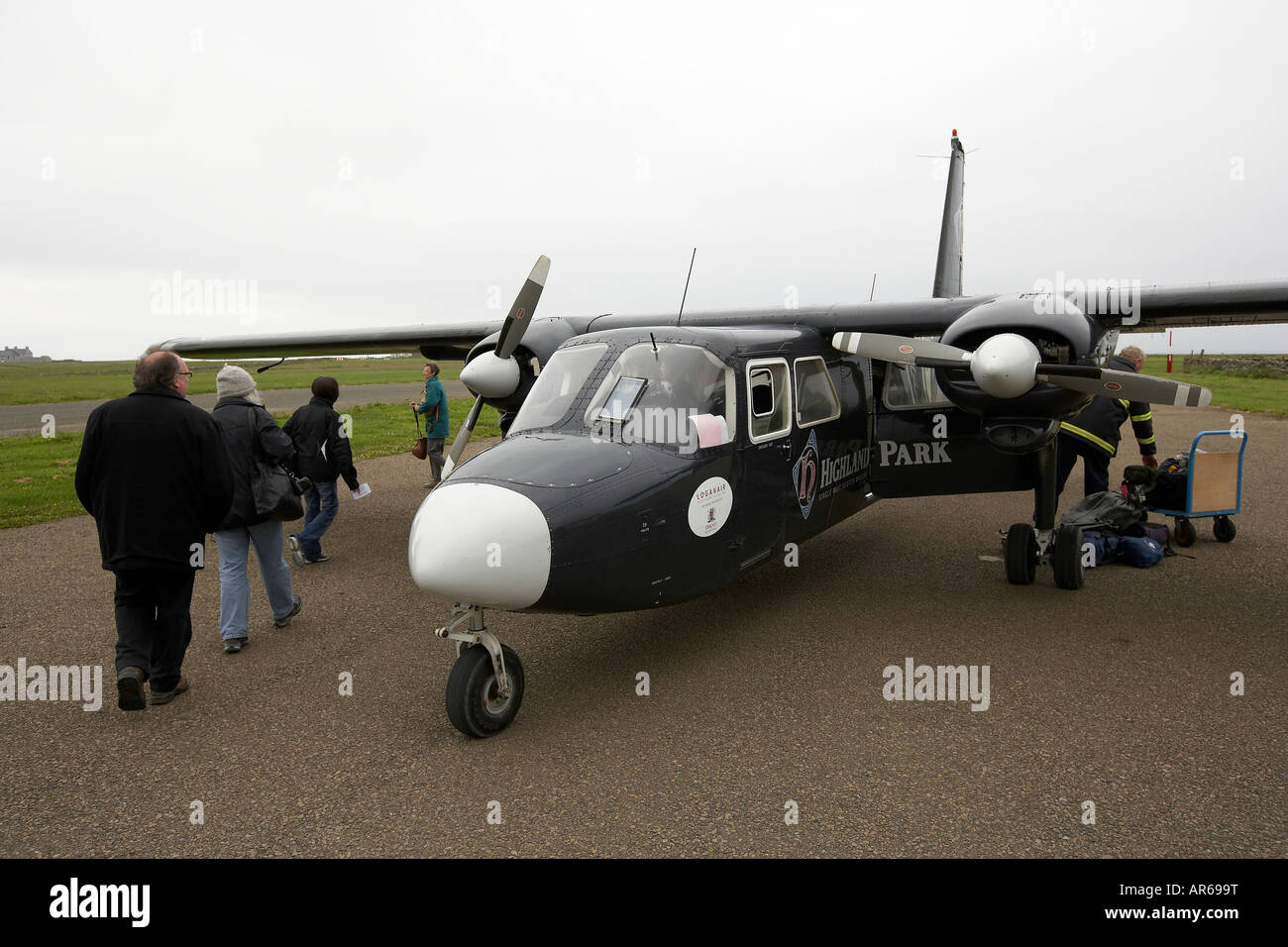 Britten Norman Islander aircraft collecting passenger at North Ronaldsay Orkney Scotland UK Stock Photo