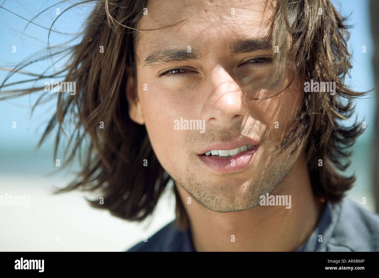 Portrait of a young man with long hair Stock Photo - Alamy