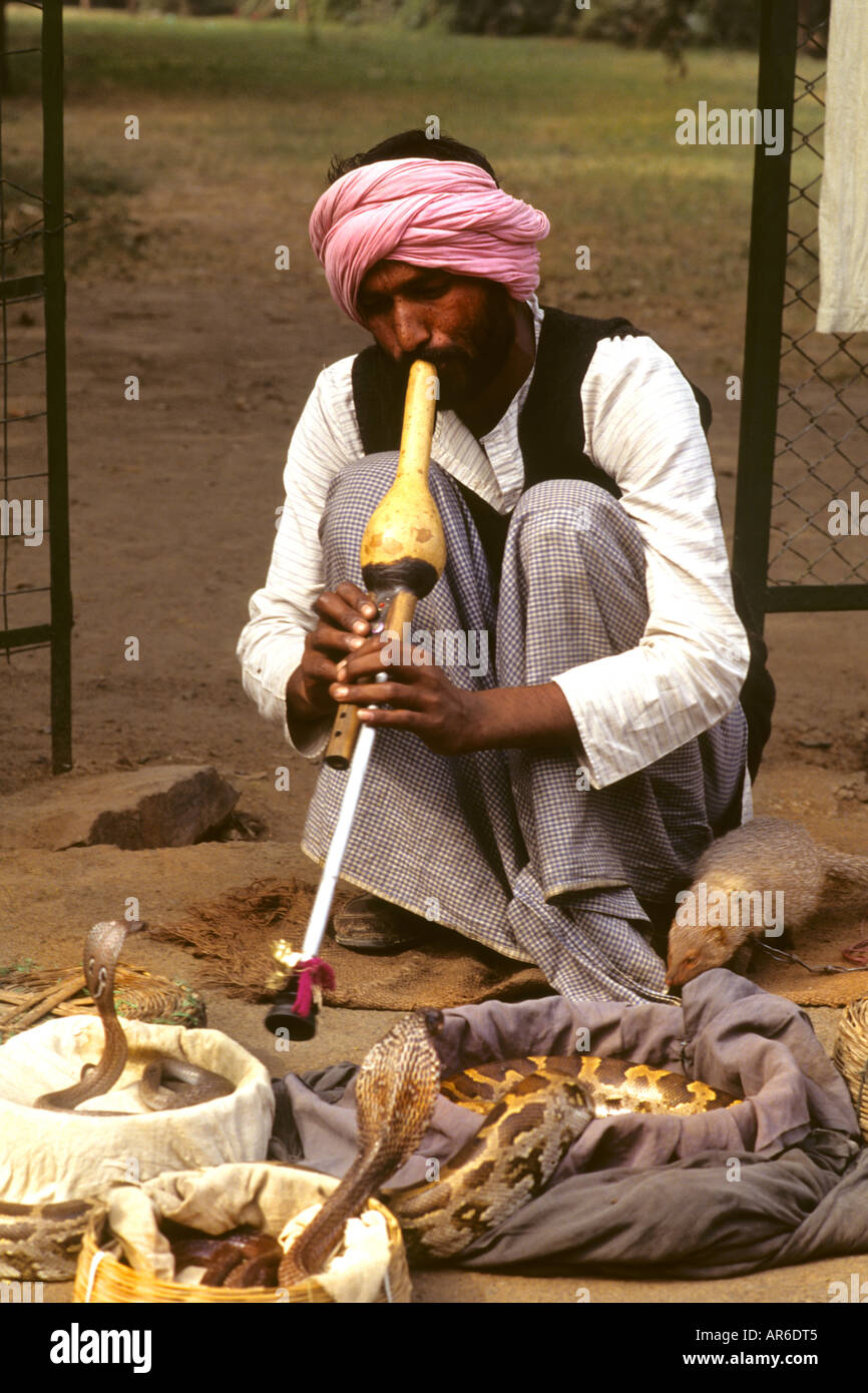 Snake charmer on streets of Delhi India showing snakes in baskets Stock Photo