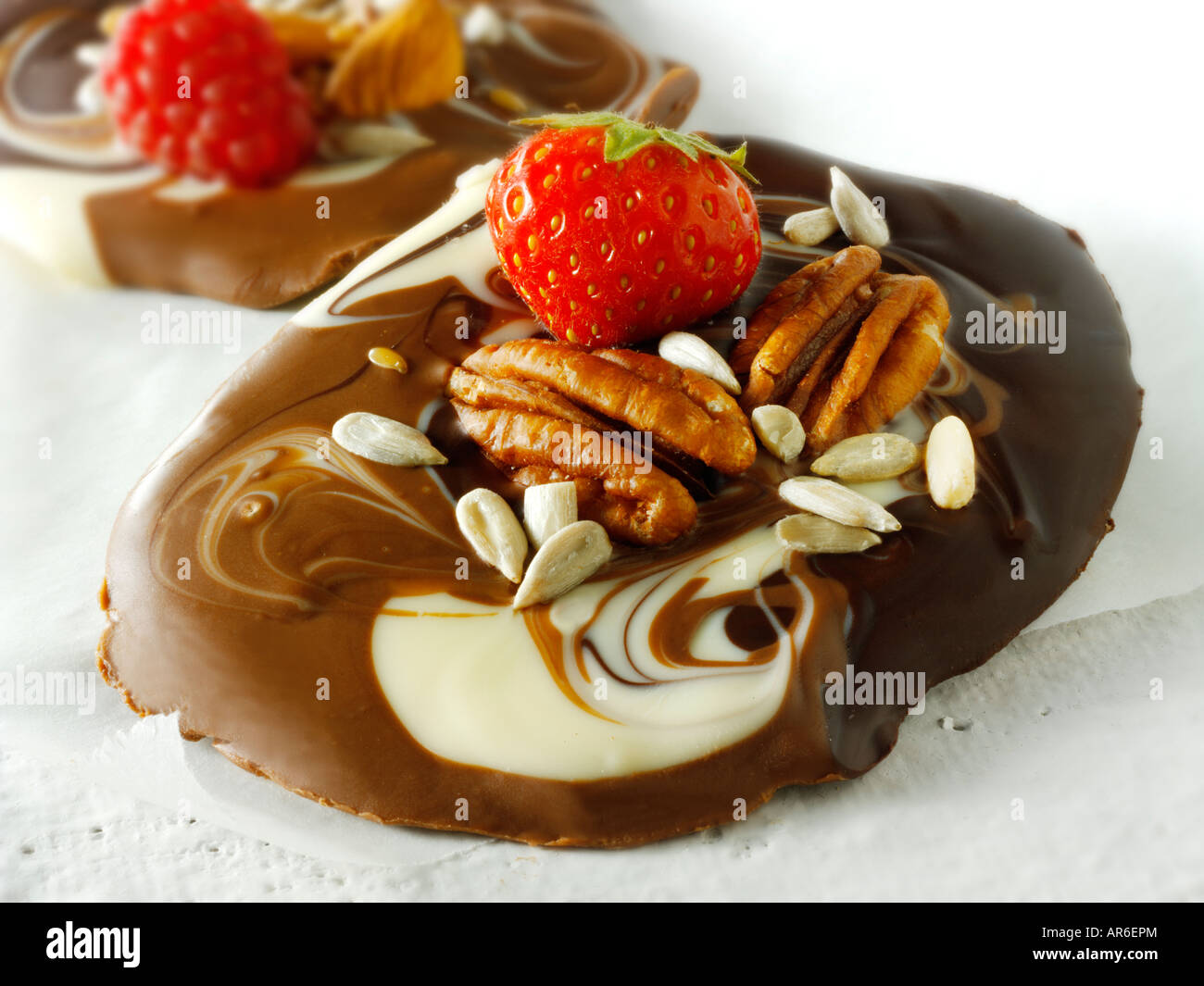 Chocolate swirls with fresh strawberries and pecan nuts Stock Photo
