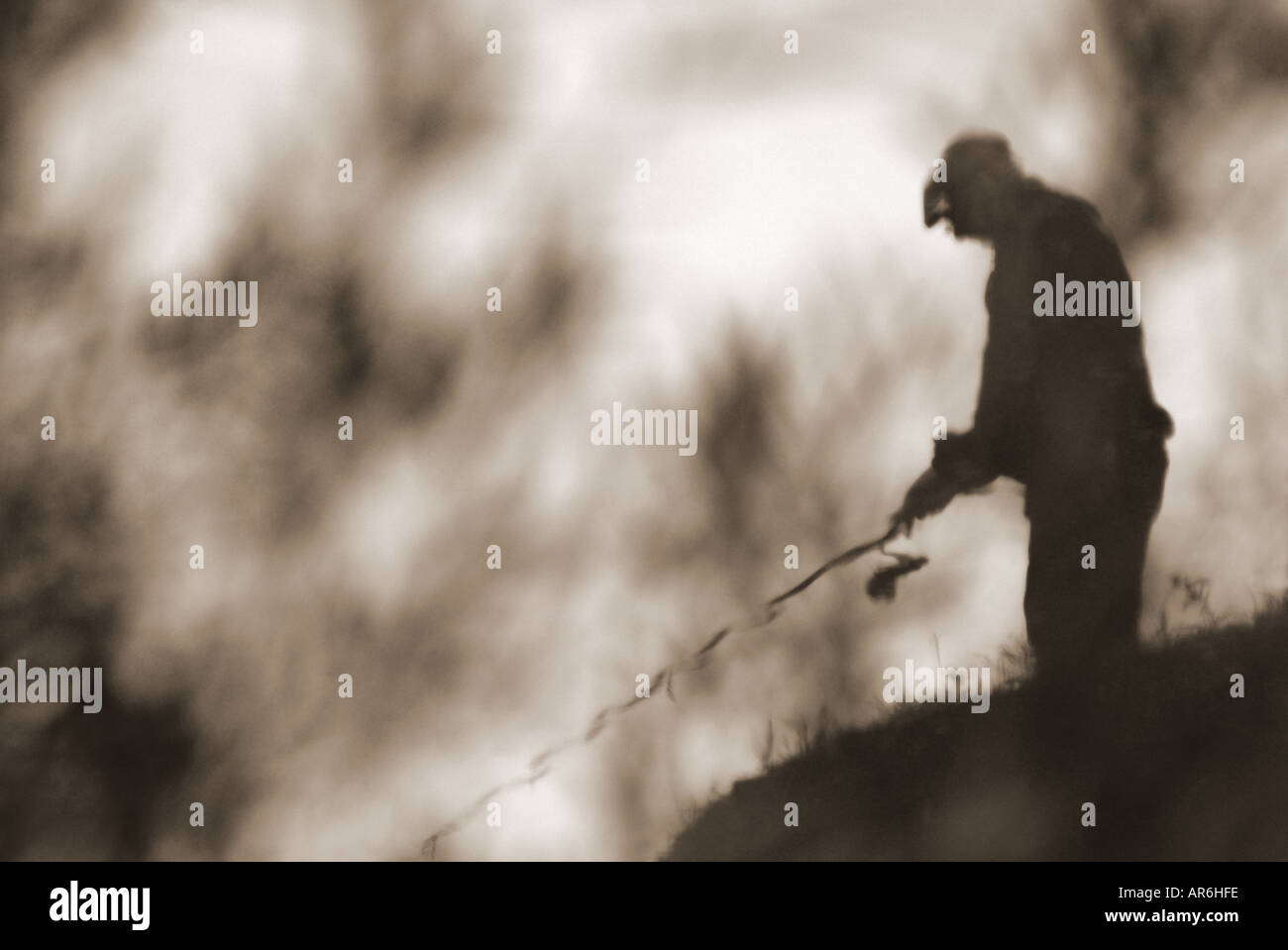 Reflection of old man fishing Stock Photo