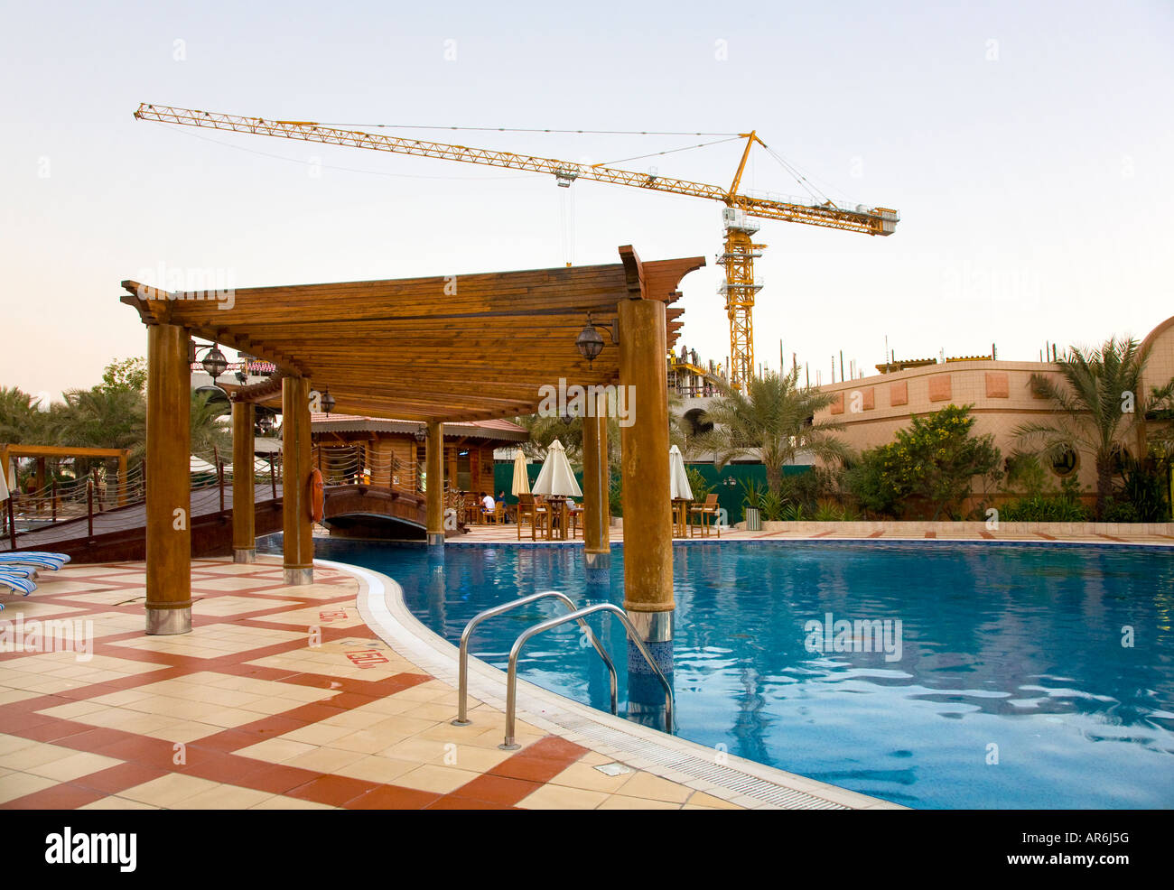 Ras Al Khaimah Beach Club UAE, Swimming Pool with Construction Crane. Stock Photo