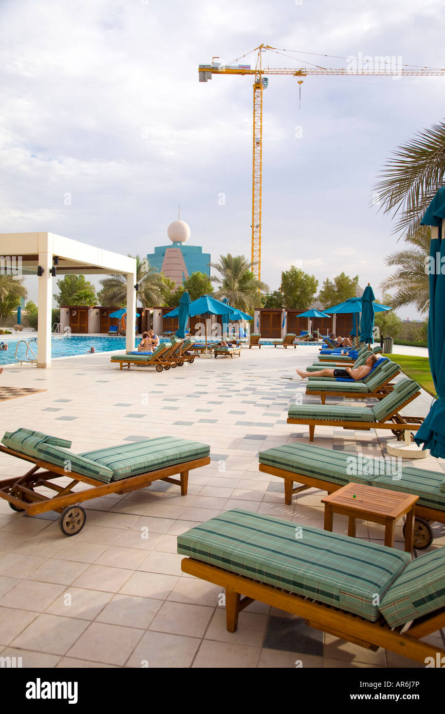 Ras Al Khaimah Beach Club UAE, Swimming Pool with Construction Crane Stock Photo