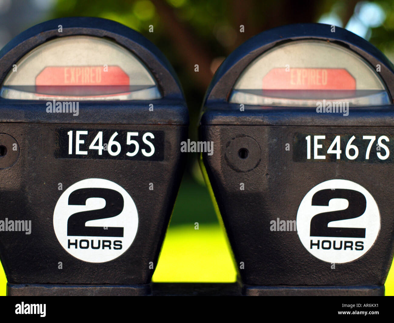Pair of coin operated parking meters in an urban area both showing