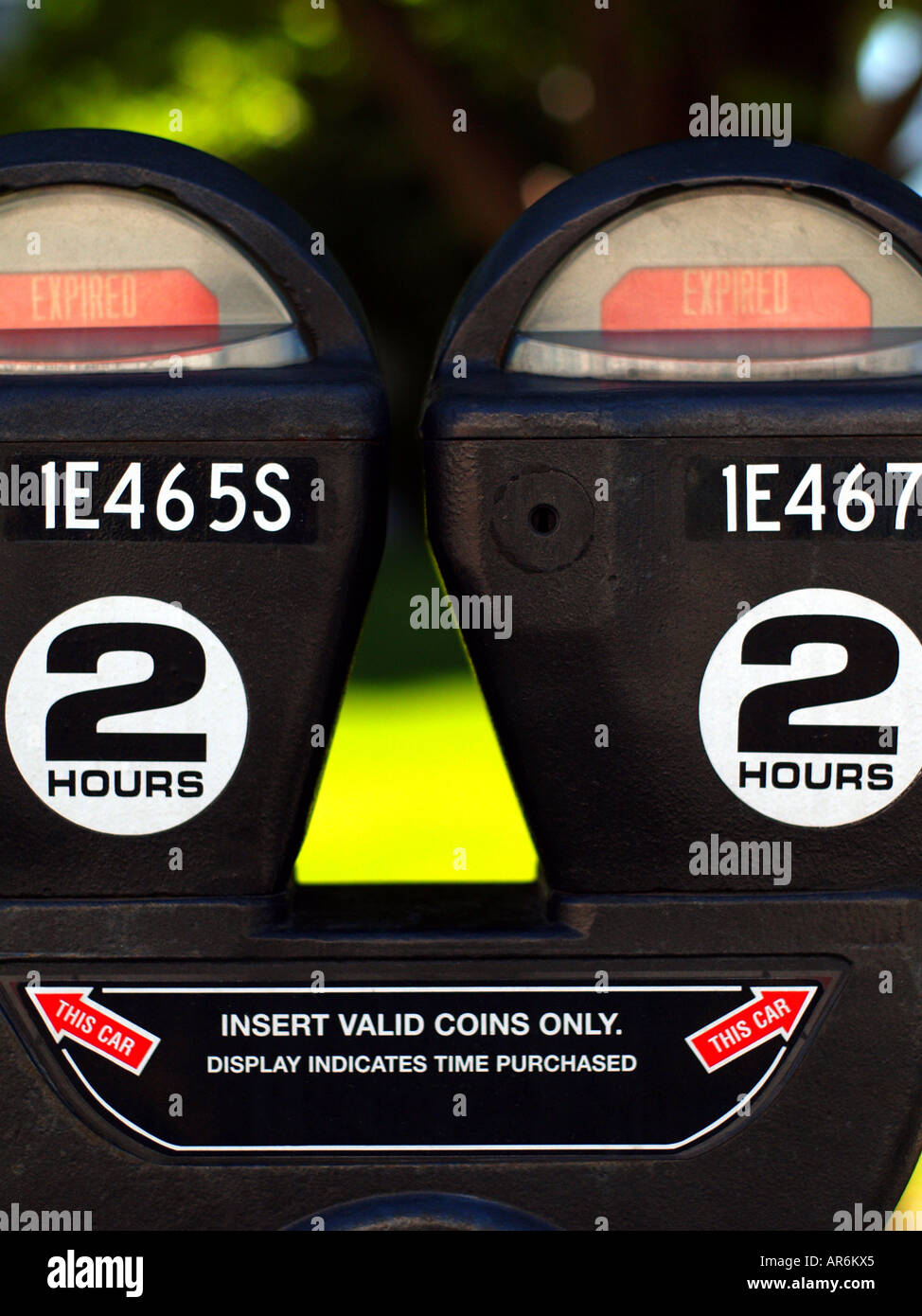 Pair of coin operated parking meters in an urban area both showing