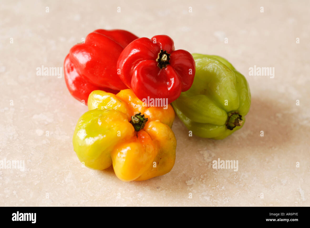 Scotch Bonnet chilli peppers on stone table Stock Photo