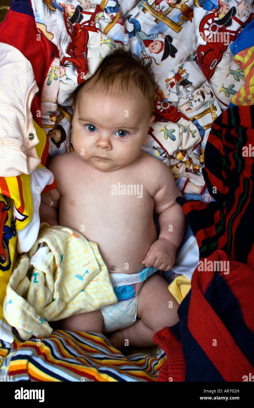 Baby in box of clothes purchased on ebay Stock Photo - Alamy