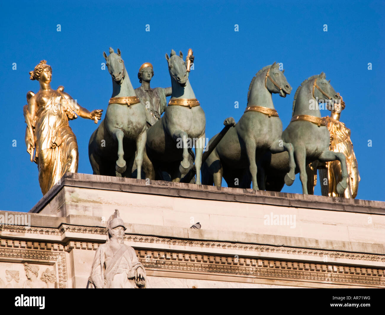 Early morning sunlight breaks on the Quadriga of the Arc de Triomphe du Carrousel, Paris, France, Europe Stock Photo