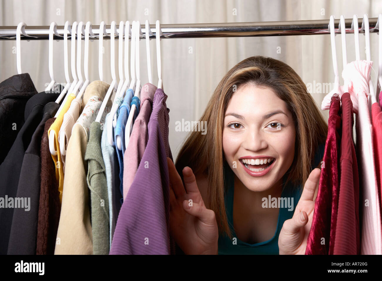 Hispanic Rack Hispanic woman looking through rack of clothing Stock Photo - Alamy