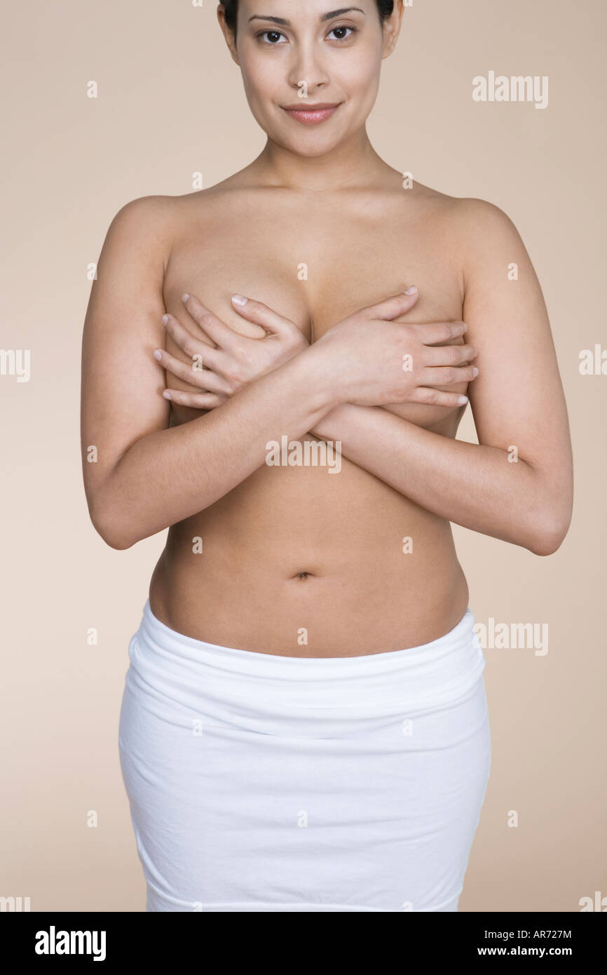 Topless woman covering her breasts Stock Photo - Alamy