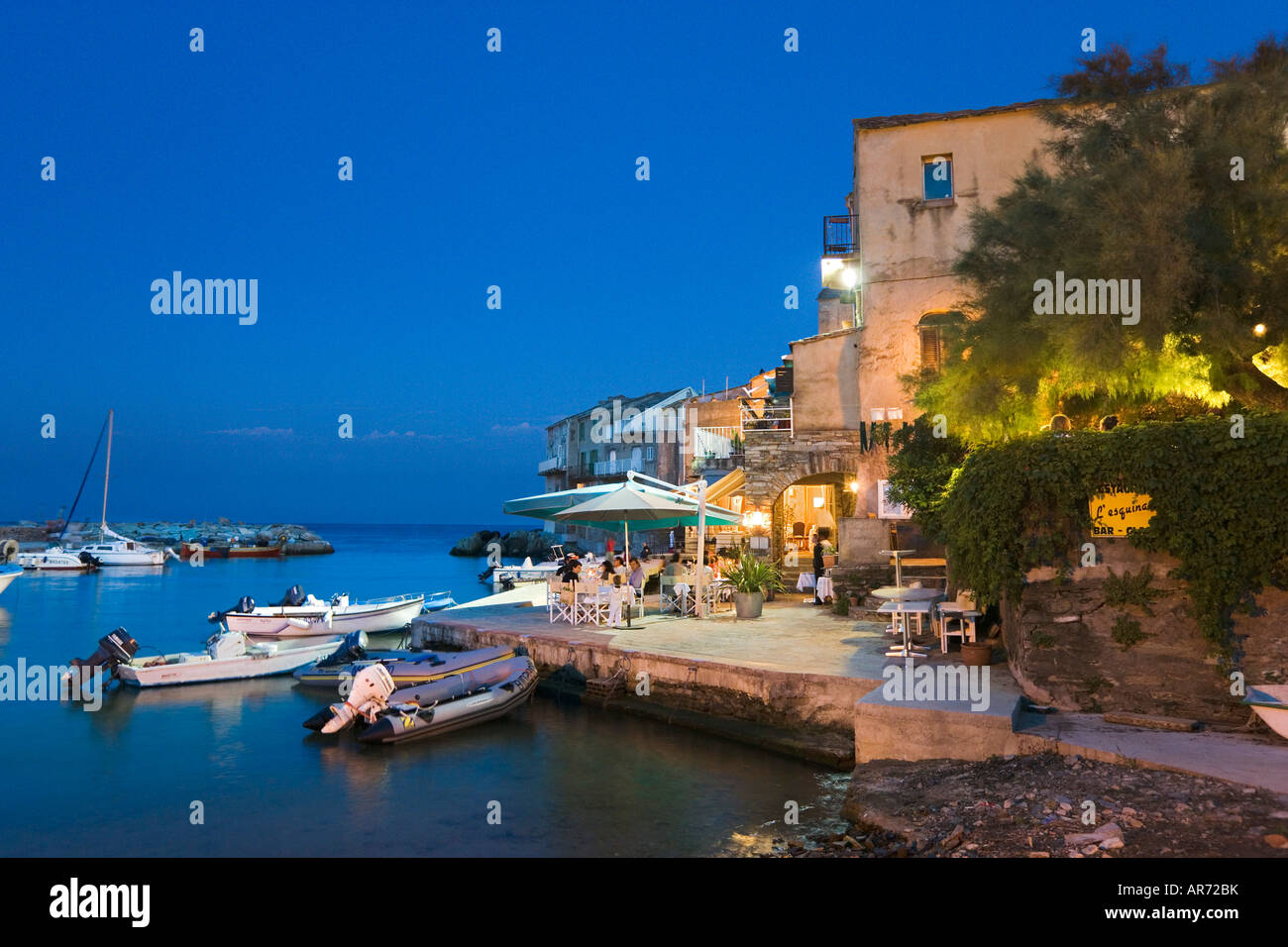 Harbourfront restaurant at night, Erbalunga, Cap Corse, Corsica, France Stock Photo