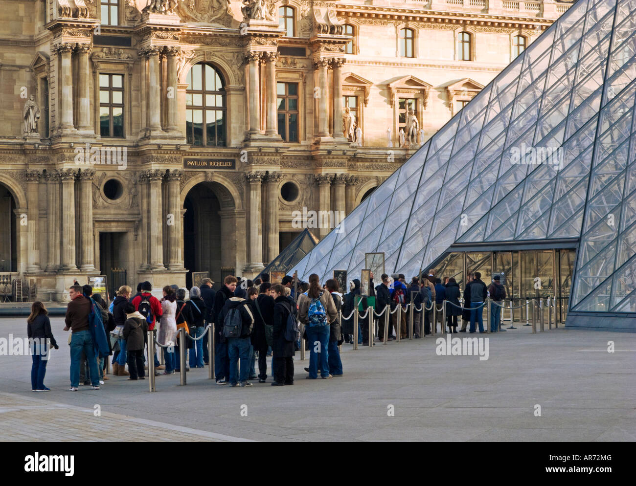 Louvre Museum, Paris, France, Europe - Visitors queue up early in the morning at the Louvre Pyramid entrance Stock Photo