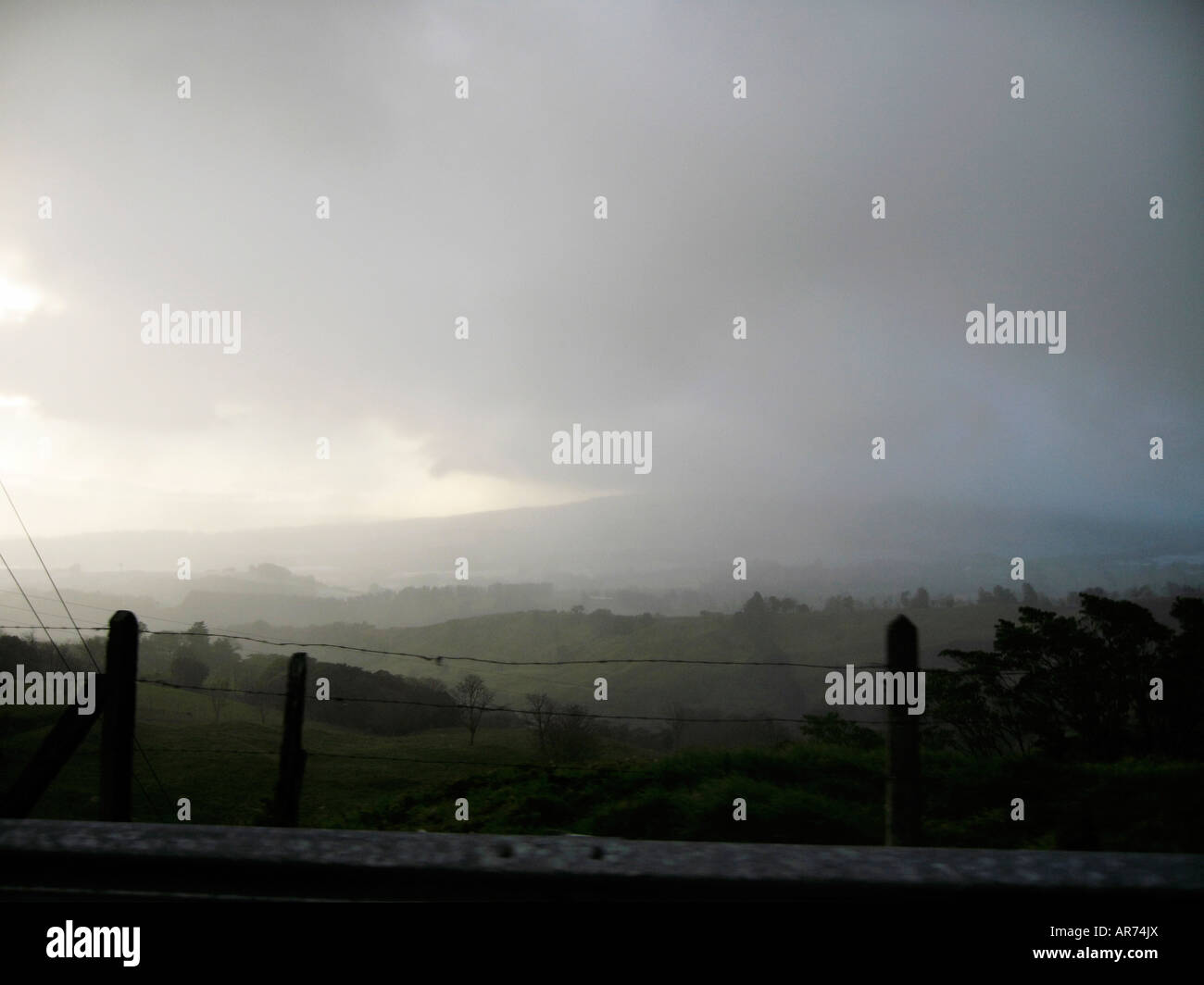 Storm clouds over a field Stock Photo - Alamy