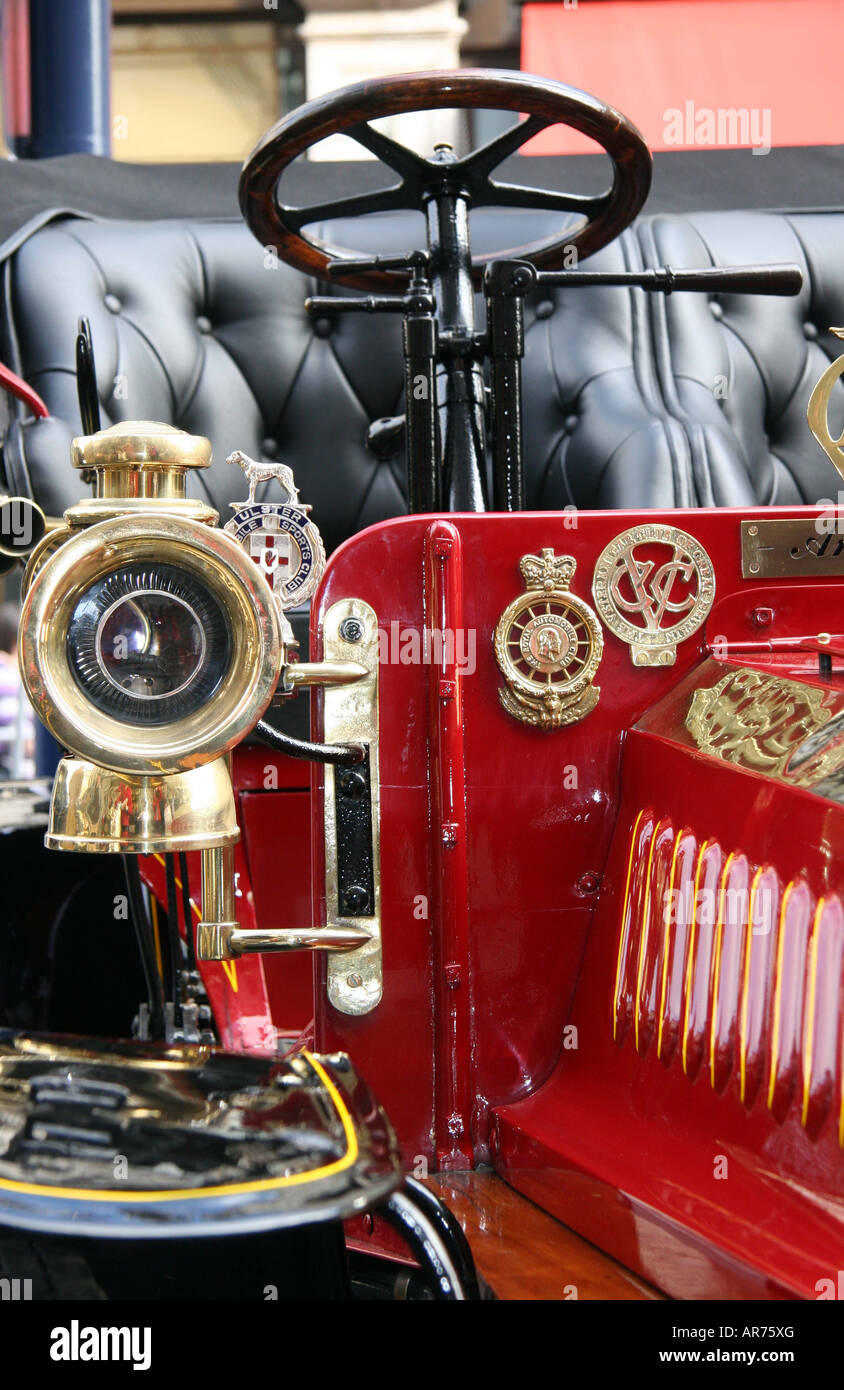 Detail on one of the veteran cars brass headlamp and leather seats, and brass automobile badges Stock Photo