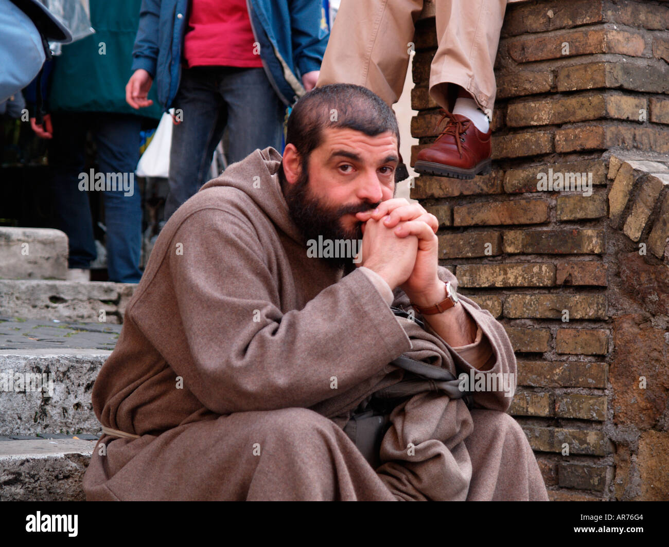 monk sat on steps looking pensive the day before funeral of Pope John Paul ll Stock Photo