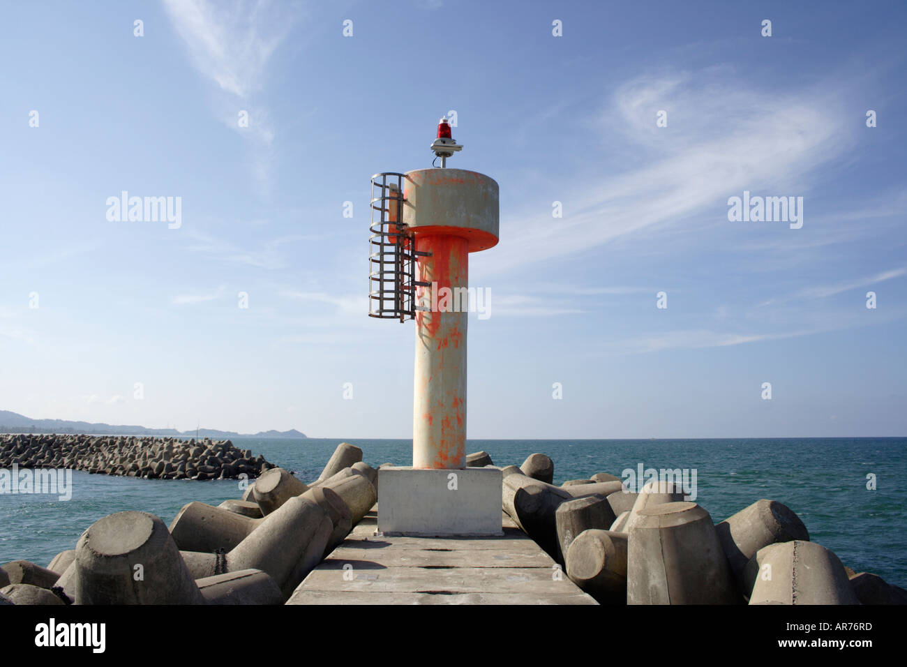 Lighthouse at the entrance of a wave breaker in Malaysia Stock Photo
