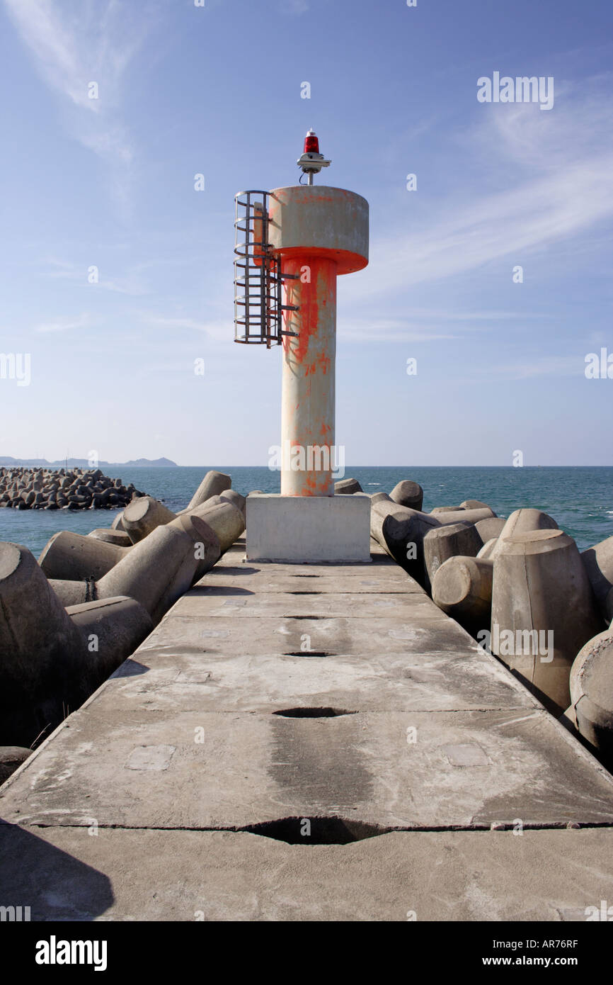 Lighthouse at the entrance of a wave breaker in Malaysia. Stock Photo