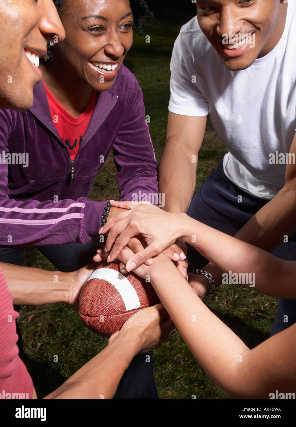 Multi-ethnic friends playing football Stock Photo