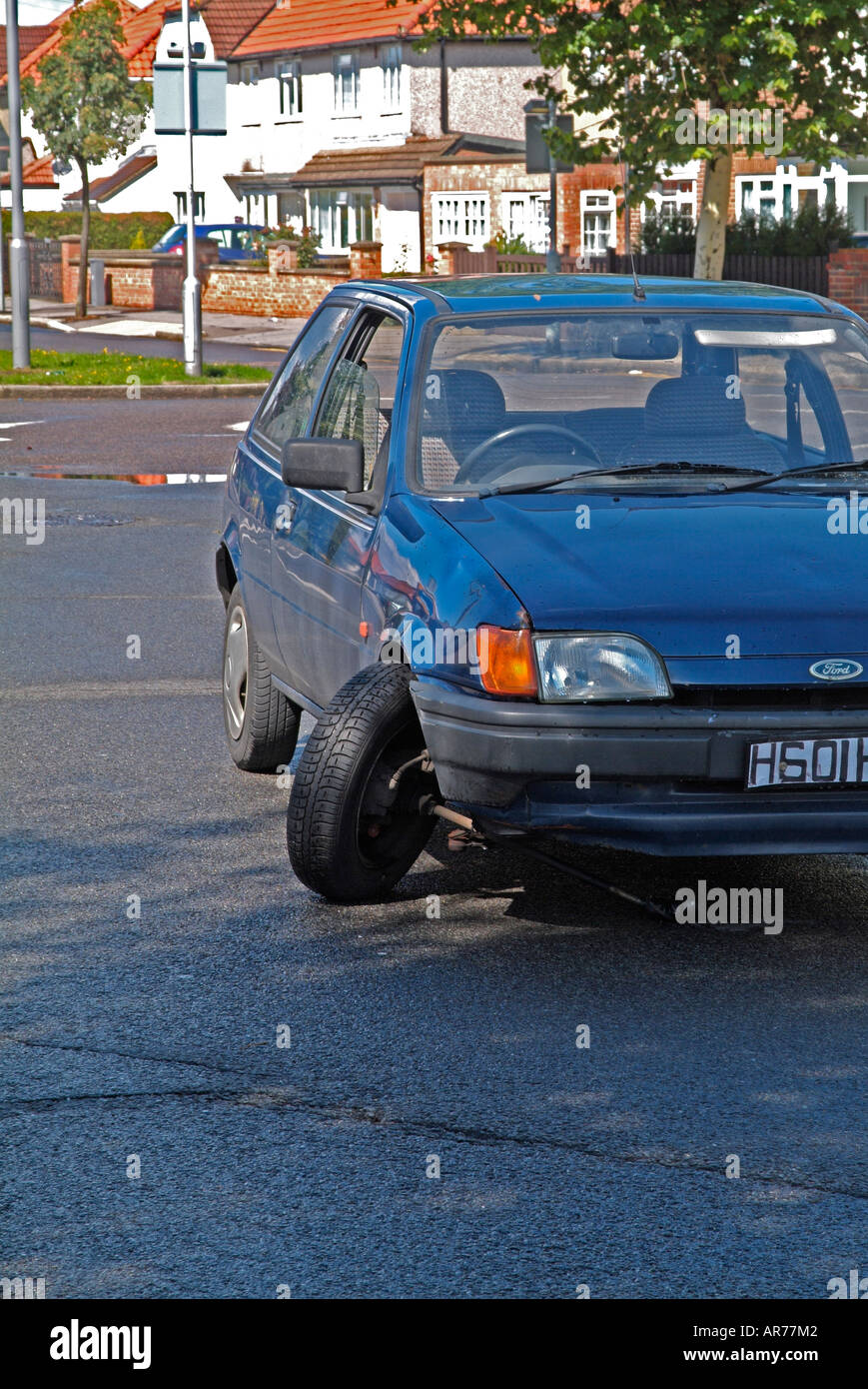 Collapsed suspension on car Stock Photo