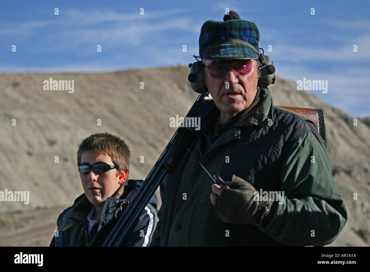 Teenage boy and his grandfather ready to shoot sporting clays in Pinedale, Wyoming, USA Stock Photo