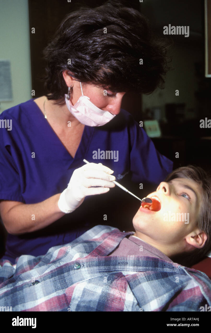 Dentist Examining a Boys Teeth and Mouth Stock Photo