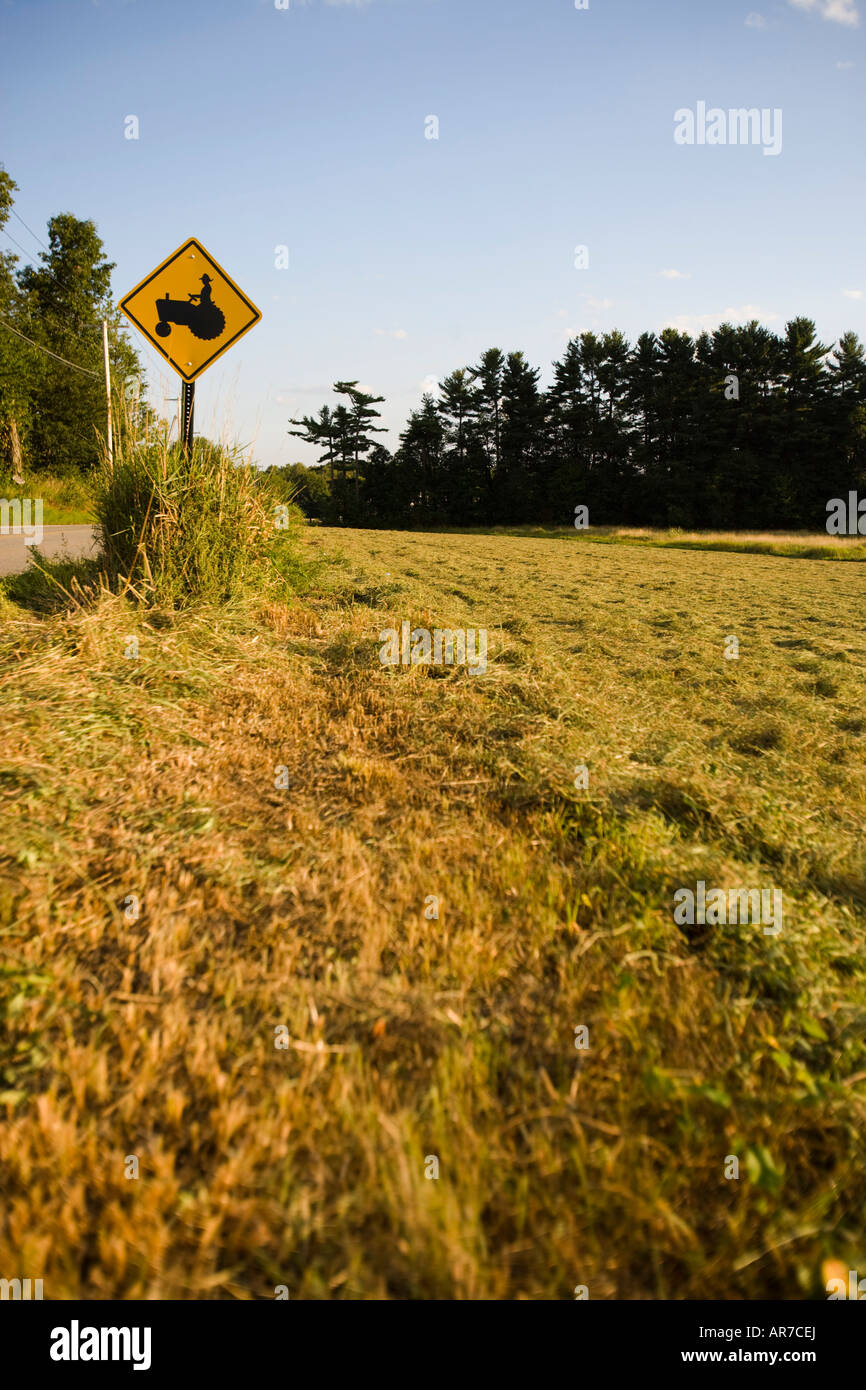 A tractor crossing sign next to a farm in Pepperell, Massachusetts