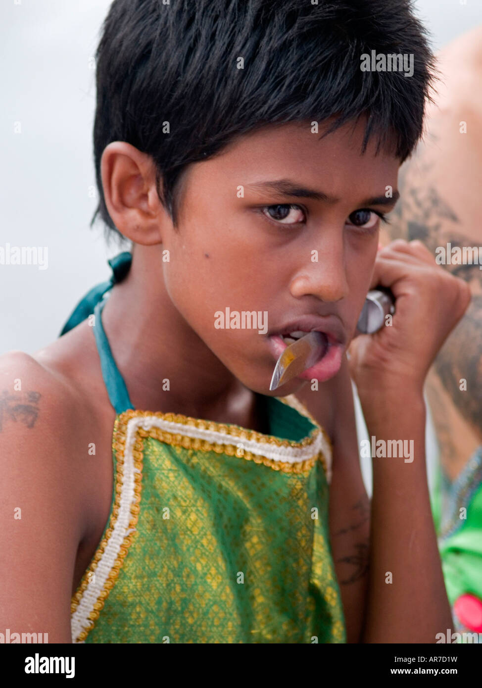 boy with a knife in his mouth at the bizarre Vegetarian Festival Phuket