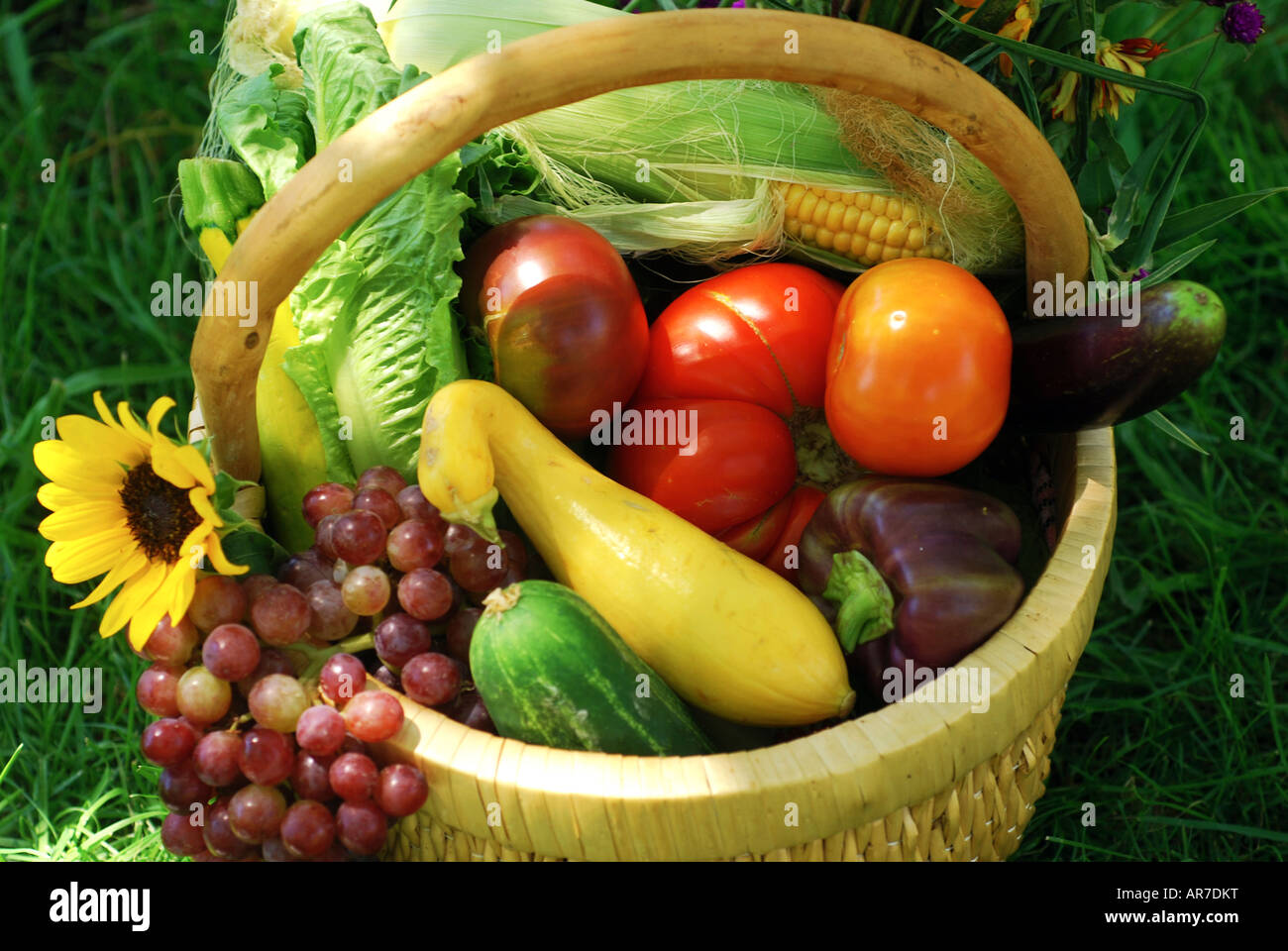 Wicker basket filled with fruits vegetables and flower fresh from the ...