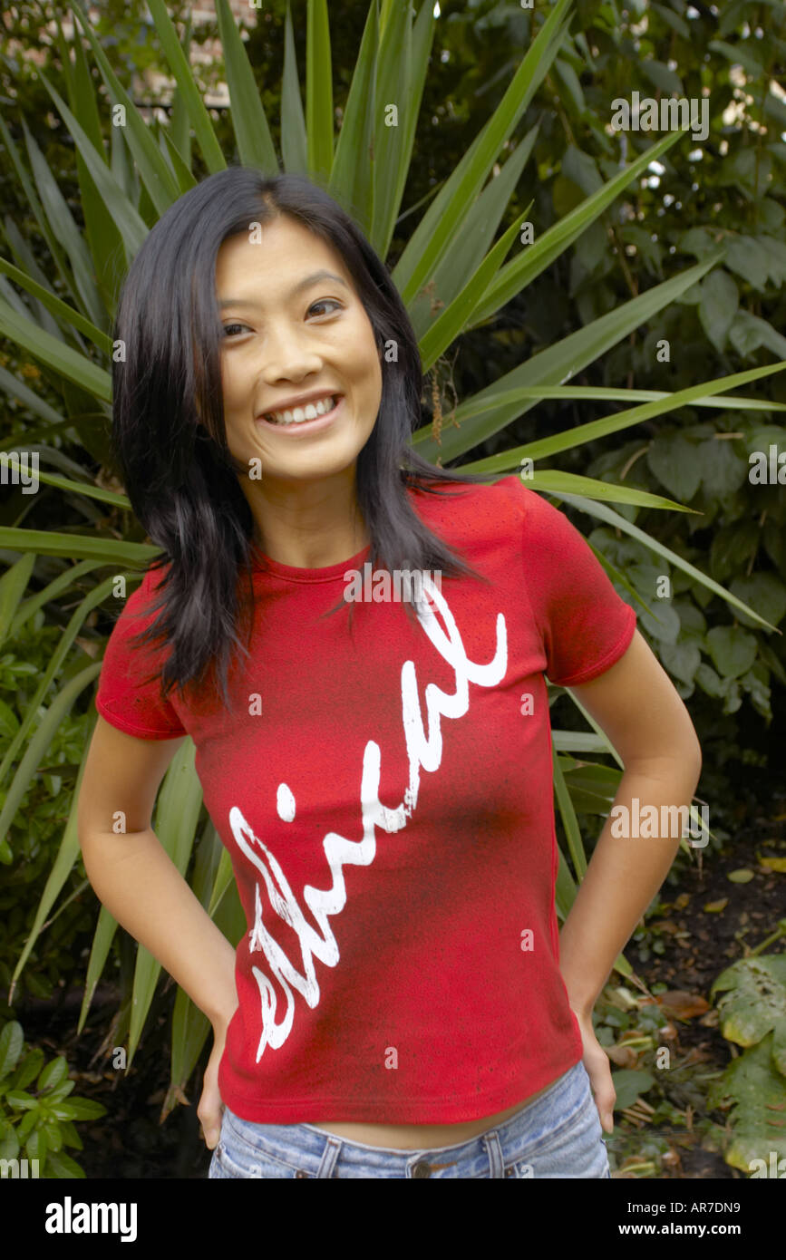 smiling oriental woman wearing red tee shirt with ethical slogan made by ethical tees limited Stock Photo