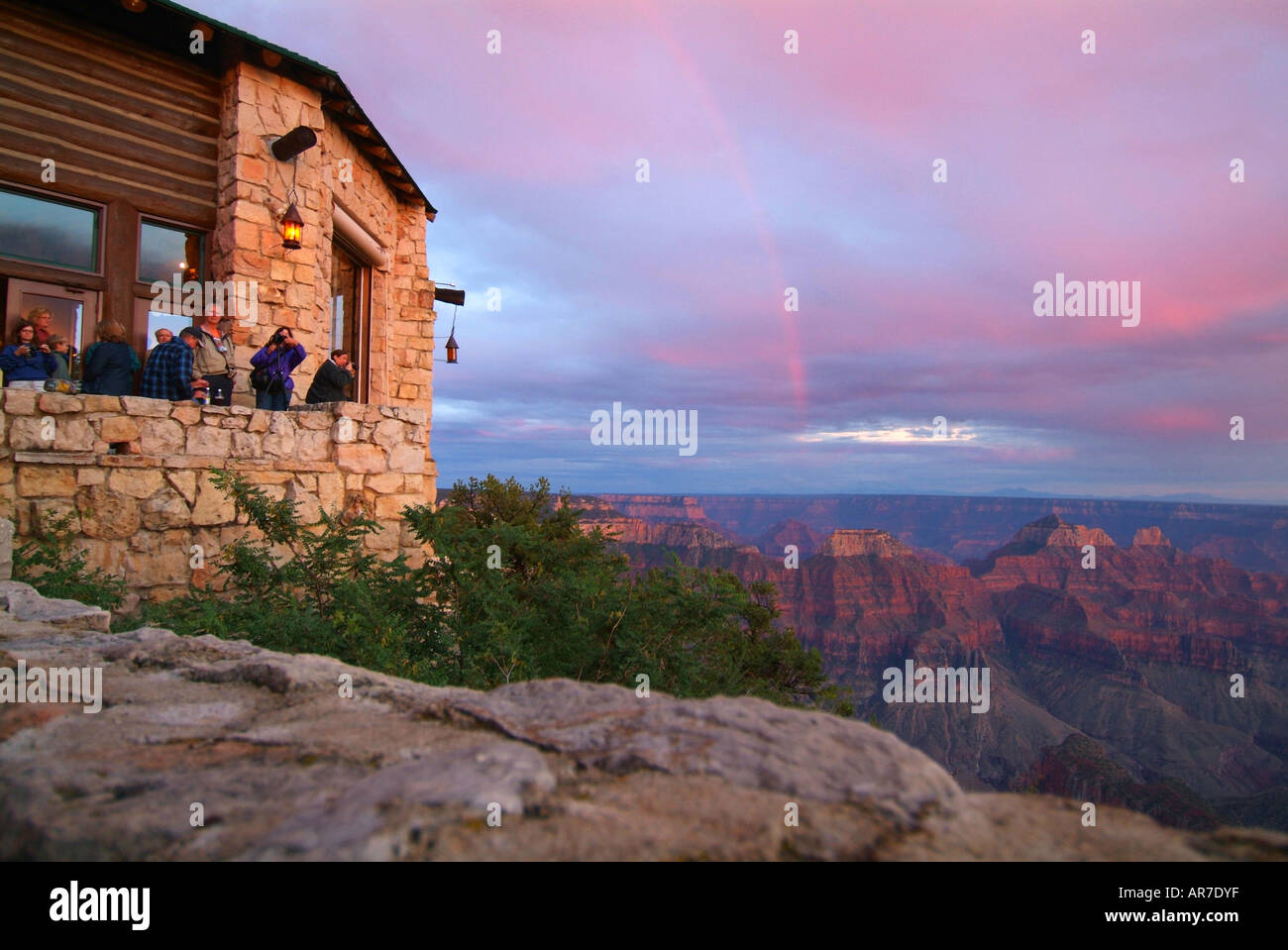 People take in the sunset from the lodge at the North Rim of the Grand Canyon National Park Service Stock Photo