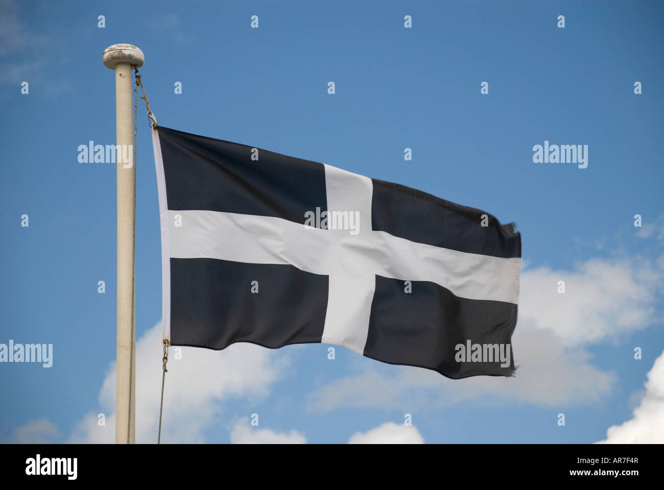 Cornish flag against blue sky Stock Photo