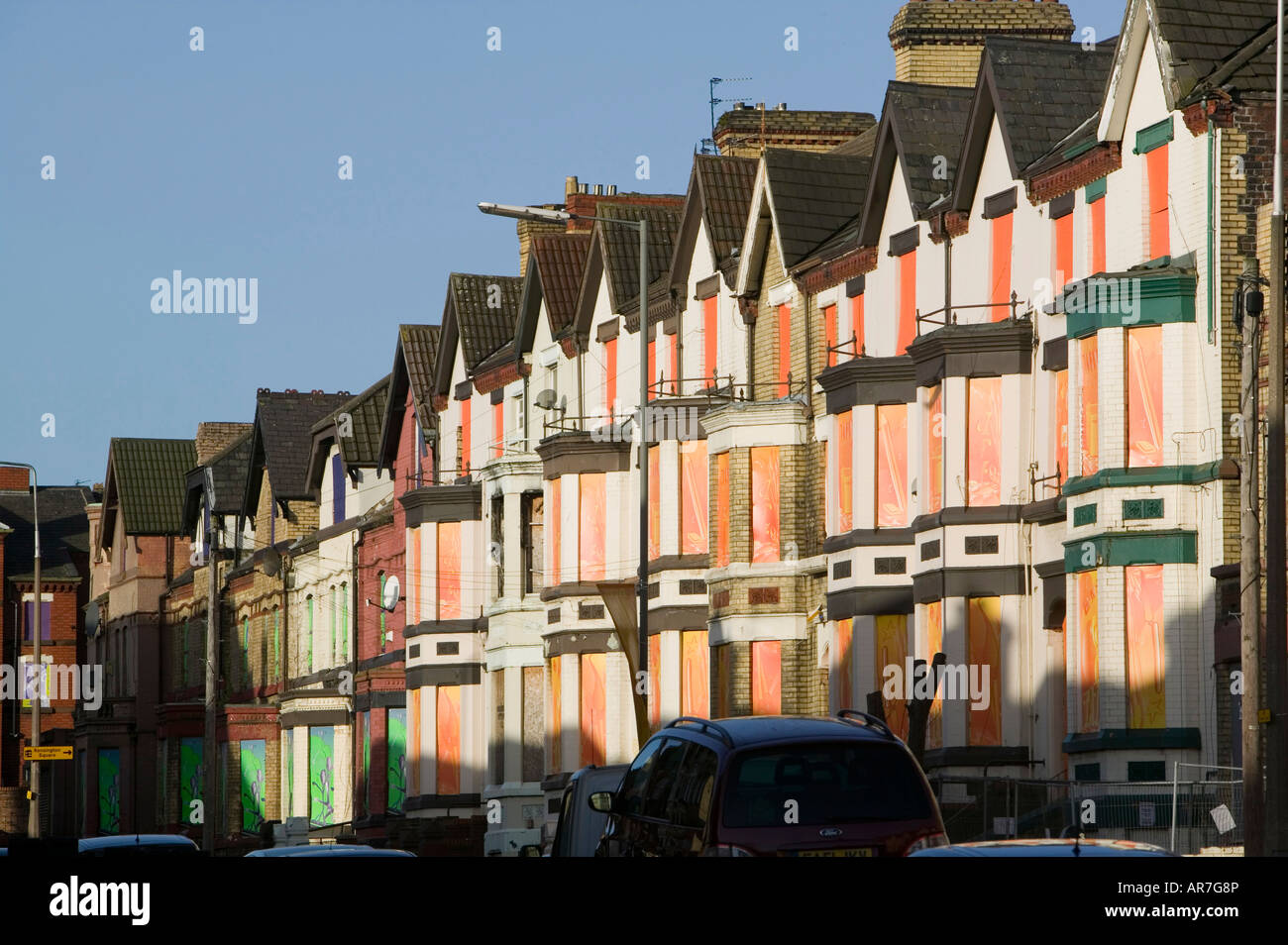 Boarded up houses on Edge Lane Liverpool using artwork to make it look  better for the 2008 City of Culture year Stock Photo - Alamy