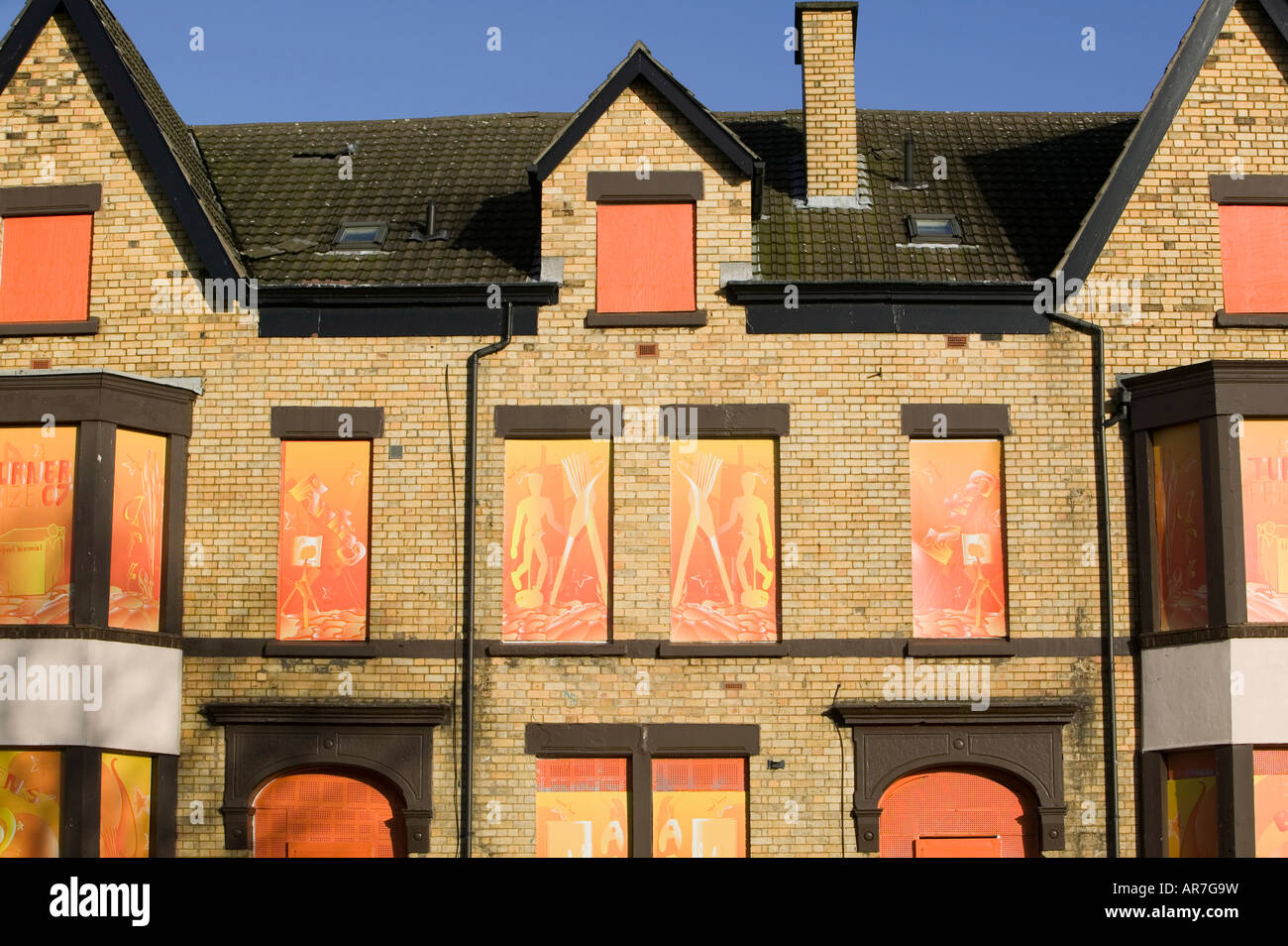 Boarded up houses on Edge Lane Liverpool using artwork to make it look