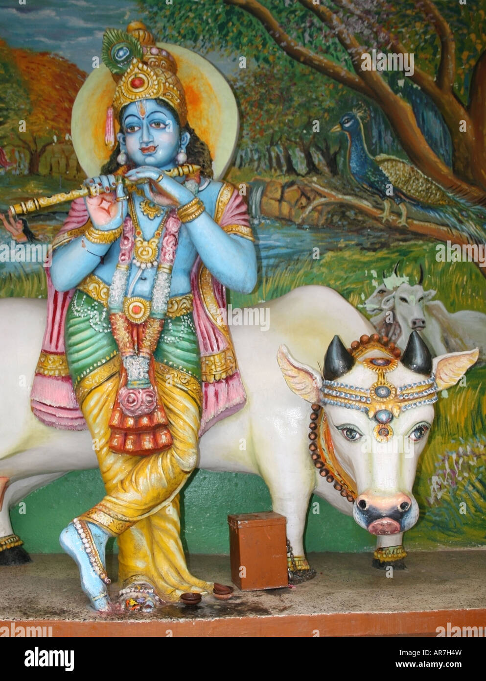 Statue of Hindu deity Krishna and his pet cow , Hyderabad , India Stock Photo