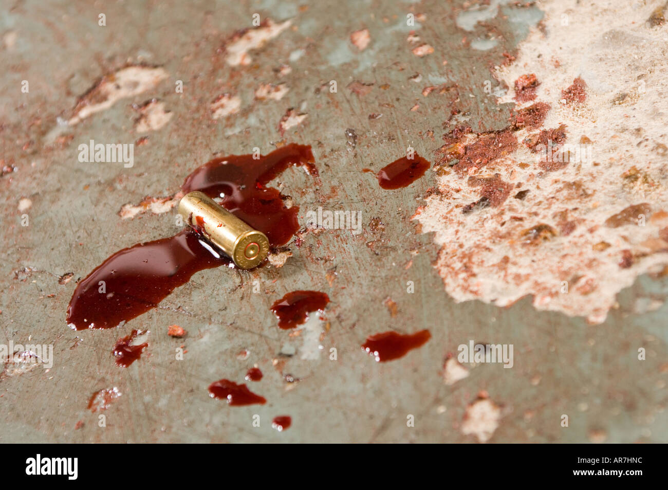 bloodstains on a floor with a bullet casing Stock Photo